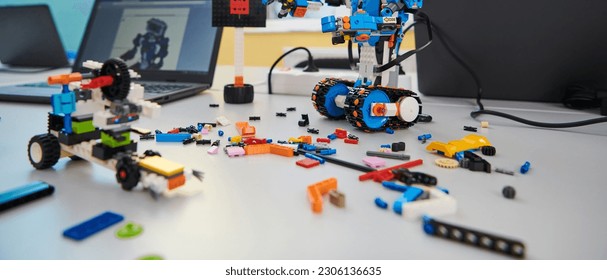 Various components and installations for robot fabrication fill the space, representing the intricate blend of technology, engineering, and innovation involved in the development and assembly of