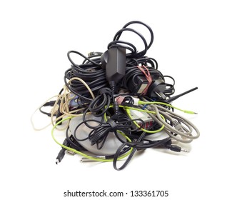 Various Computer And Electronics Cables Gathered Together Into A Messy Heap, Isolated On White.