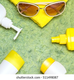 Various cosmetic sunscreen products for face and body skin care, towel and sunglasses. Lotion, milk, spray and cream. Cosmetics containing sun protection factor