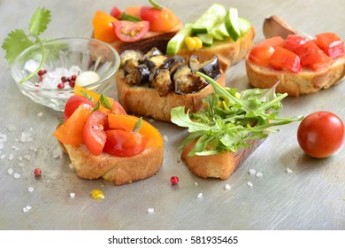 Various crostini with vegetables and herbs