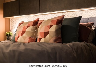 Various cushions and pillows on the bed