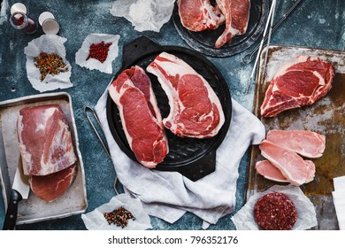 Various Cuts Of Beef And Pork Steak On A Grilled Tray. Overhead Of Beef And Pork Steaks Meat With Spices.