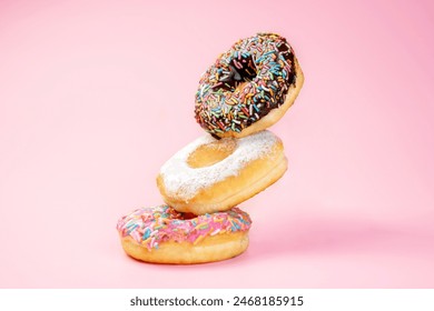 Various delicious donuts with different sprinkled decorations on a colored background - Powered by Shutterstock