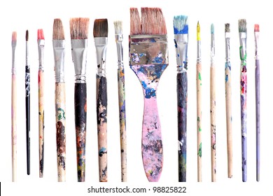 Various dirty paint brushes displayed side by side