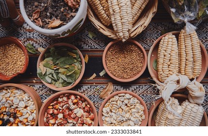 Various dried spices, andean cereals and grains in small bowls and raw herbs, pachamama payment, andean peruvian culture