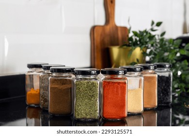 Various dried spices in glass jars