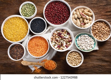 Various dry legumes on wooden board. Top view - Shutterstock ID 1227543988
