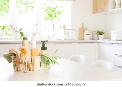 Various eco cleaning products in basket on table with blurred kitchen interior as background - Powered by Shutterstock