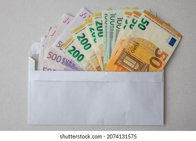 Various fanned out Euro banknotes in an envelope as a background image for financial topics.