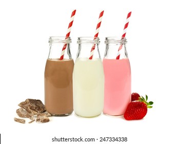 Various flavors of milk in bottles with chocolate and strawberries isolated on white                           - Powered by Shutterstock