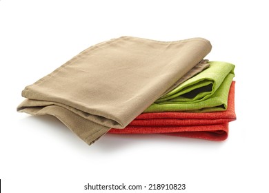 various folded cotton napkins isolated on a white background