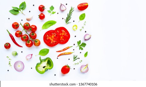 Various fresh vegetables and herbs on white background. Cooking ingredients and healthy eating concept. Copy space