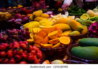 Various Fruits Salad On Glass Bowl Such As Orange,lemon,tomato,grape,mango,pineapple For Customer To Choose The Quality And Healthy Organic Fruit At The Salad Bar Restaurant.