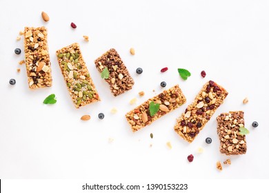 Various Granola Bars Isolated On White Background, Copy Space. Homemade Healthy Snack - Granola Superfood Bars.