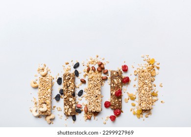 Various granola bars on table background. Cereal granola bars. Superfood breakfast bars with oats, nuts and berries, close up. Superfood concept. - Powered by Shutterstock