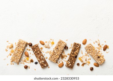 Various granola bars on table background. Cereal granola bars. Superfood breakfast bars with oats, nuts and berries, close up. Superfood concept. - Powered by Shutterstock