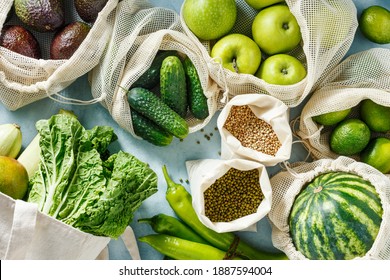 Various Green Vegetables, Fruits And Grains In Reusable Bags. Top View. Eco Friendly Shopping. Sustainable Lifestyle Concept.