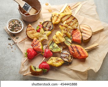 Various Grilled Fruit Pieces On Wooden Skewers