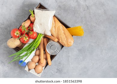 Various Grocery Food And Fresh Vegetables In A Cardboard Box Top View. Food Donations Or Food Safe Delivery Concept.	