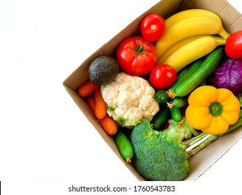 Various Grocery Items In Cardboard Box Isolated On White Background. Food Box With Fresh Vegetables, Fruits. Top View. Eco Friendly Responsible Lifestyle And Shopping. Healthy Eating. Copy Space