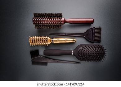 Various Hair Dresser Tools On Black Background With Copy Space