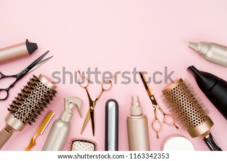 Various hair dresser tools on pink background with copy space