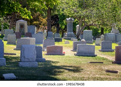 Various headstones and gravestones at a cemetery - Shutterstock ID 1985678438