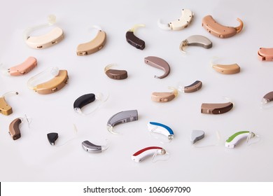 Various Hearing Aids On White Background, Alternative To Surgery. ENT Accessory