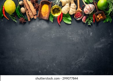 Various Herbs And Spices On Black Stone Plate