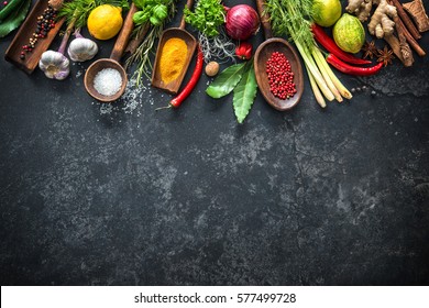 Various herbs and spices on black stone plate - Shutterstock ID 577499728