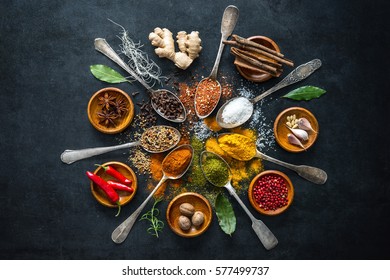 Various herbs and spices on black stone plate - Powered by Shutterstock