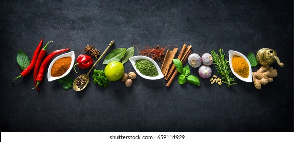 Various herbs and spices on dark background