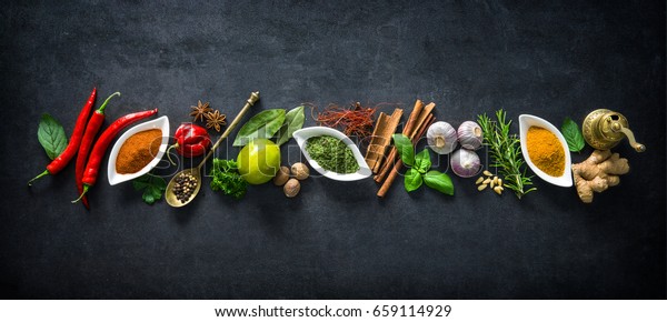 Various herbs and spices on dark background