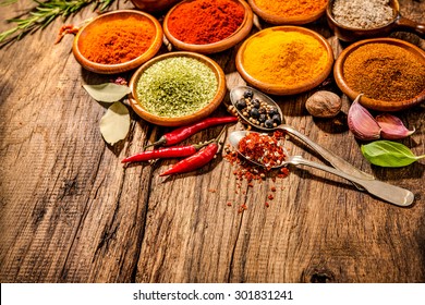 Various herbs and spices on wooden table