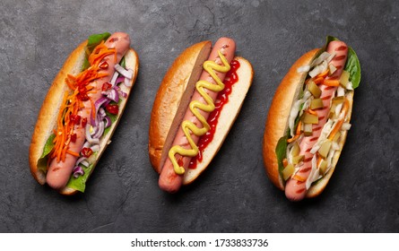 Various Hot Dog With Vegetables, Lettuce And Condiments On Stone Background. Top View. Flat Lay