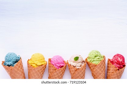 Various of ice cream flavor in cones blueberry ,strawberry ,pistachio ,almond ,orange and cherry setup on white wooden background . Summer and Sweet menu concept. - Shutterstock ID 719123104