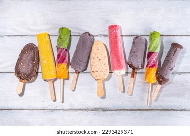 Various ice cream popsicle on white wooden background, summer sweets, dessert, vacation and holiday background, Set of assorted flavors popsicle lollipops - chocolate, vanilla, fruit, rainbow  - Shutterstock ID 2293429371