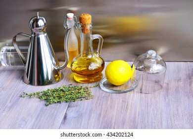 Various ingredients for salad dressing: olive oil, vinegar, balsamic or soy sauce, fresh lemon, thyme in glass and steel jugs, bottles
 - Powered by Shutterstock