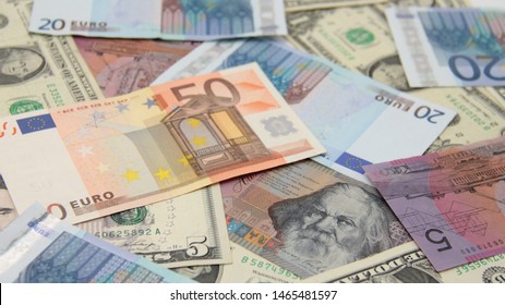 Various international paper money under white light.