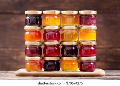 various jars of fruit jam on wooden table - Powered by Shutterstock