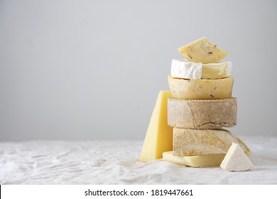 Various kind of cheese, traditional pieces of Spanish, French, Italy cheese. Light background with copy space, table with gray linen tablecloth - Powered by Shutterstock