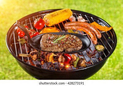 Various kind of meat served on grill with grass on background - Shutterstock ID 428273191
