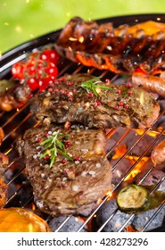 Various kind of meat served on grill with grass on background - Shutterstock ID 428273296