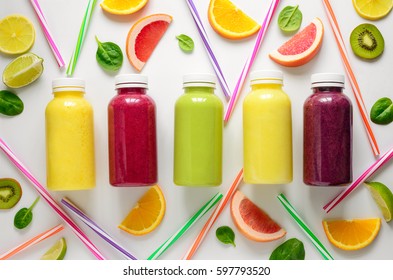 Various kind of smoothies or juices in bottles, healthy diet food concept, view from above