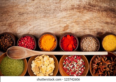 Various kind of spices in wooden bowls - Powered by Shutterstock