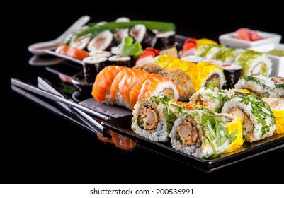 Various kind of sushi food served on black background