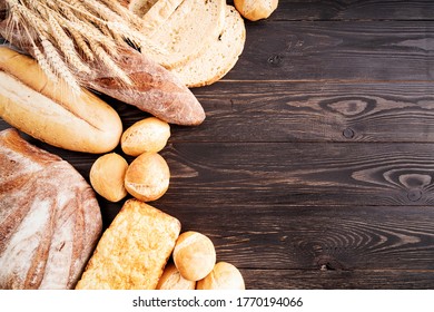 Various Kinds Of Bread On Dark Wooden Table Flay Lay