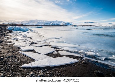 Various kinds of ice at jokulsarlon glacier lagoon, iceland with the mountain and clear sky. - Powered by Shutterstock