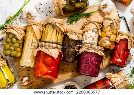 Various kinds preserves vegetables and mushrooms in glass jars.