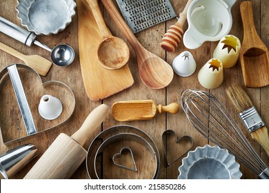 various kitchen utensils on wooden table - Shutterstock ID 215850286